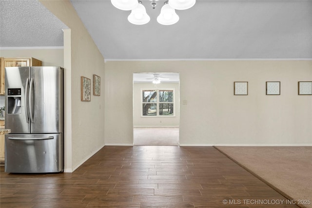 interior space featuring baseboards, ornamental molding, dark wood-type flooring, and ceiling fan with notable chandelier