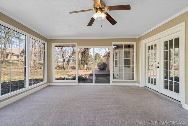 unfurnished sunroom featuring plenty of natural light and ceiling fan