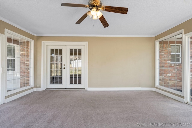 unfurnished room with carpet, ornamental molding, a textured ceiling, and french doors