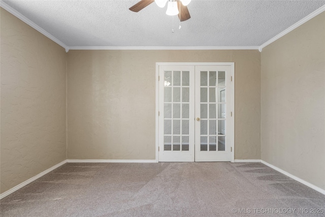 carpeted spare room featuring french doors, crown molding, a textured wall, ceiling fan, and a textured ceiling