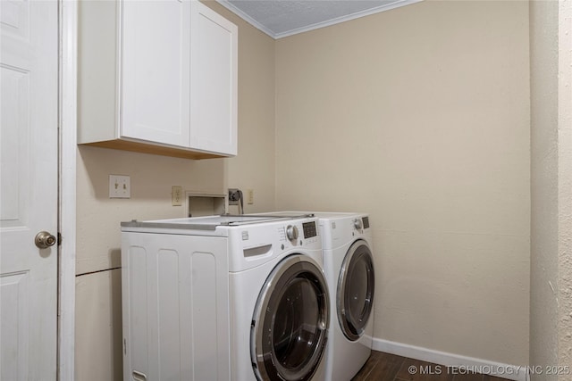 clothes washing area with cabinet space, baseboards, ornamental molding, wood finished floors, and independent washer and dryer