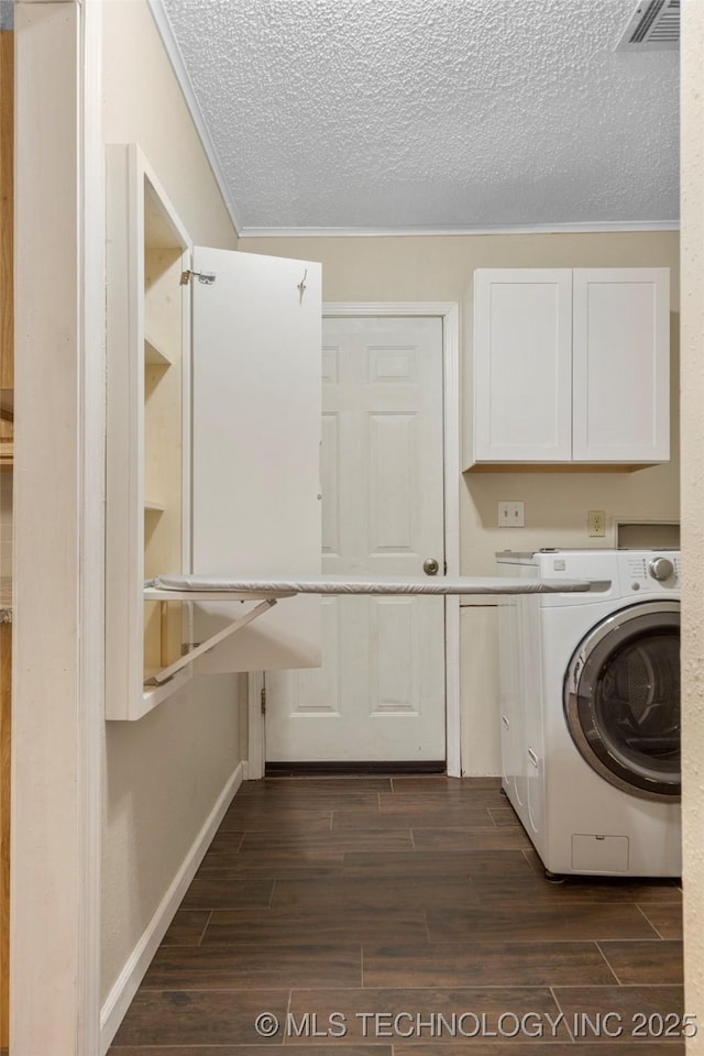 washroom with wood finish floors, cabinet space, visible vents, a textured ceiling, and washer / dryer