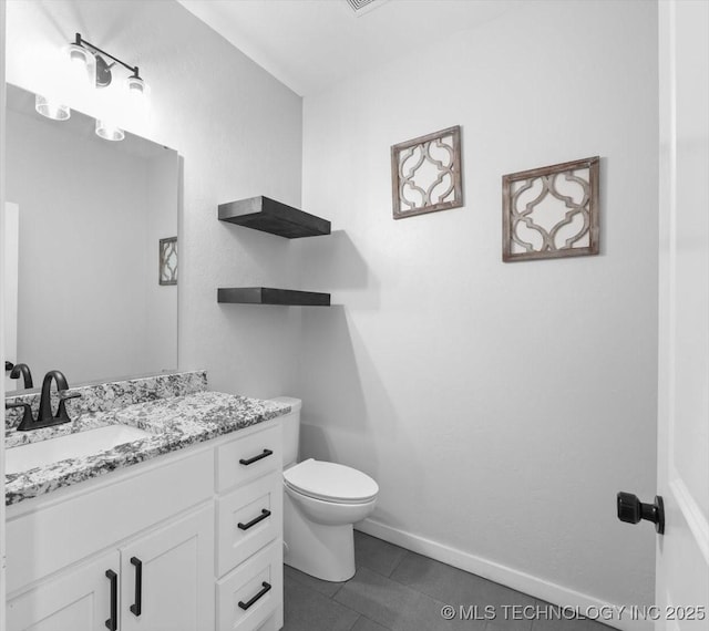 half bathroom featuring toilet, tile patterned flooring, baseboards, and vanity