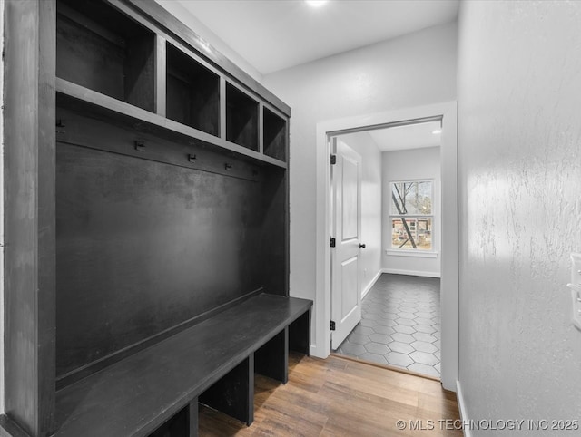 mudroom with wood finished floors and baseboards