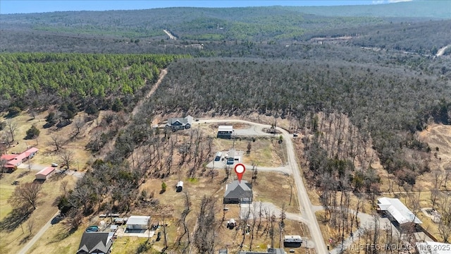 birds eye view of property featuring a view of trees