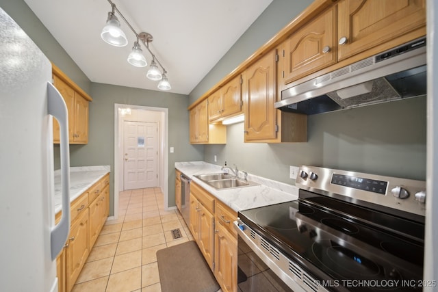 kitchen featuring under cabinet range hood, a sink, appliances with stainless steel finishes, light countertops, and light tile patterned floors