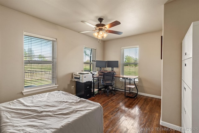 bedroom with ceiling fan, baseboards, and wood finished floors