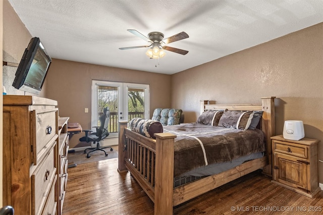 bedroom with a textured ceiling, a textured wall, dark wood-style flooring, and access to exterior