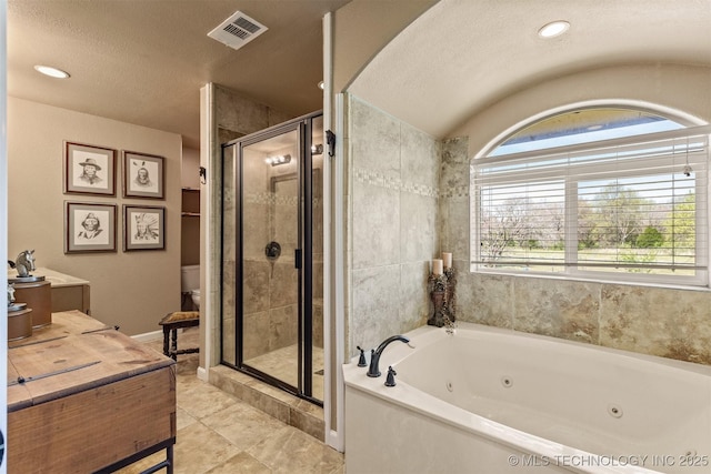 bathroom featuring a textured ceiling, toilet, visible vents, a tub with jets, and a stall shower