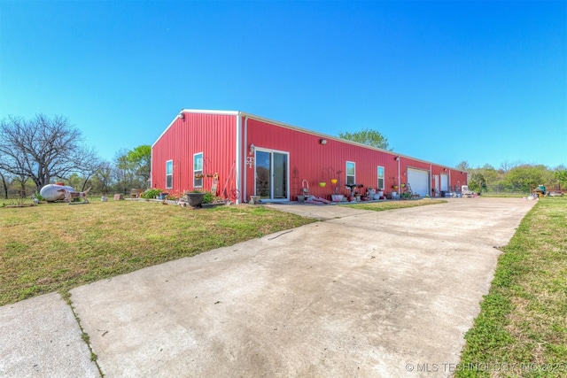 view of property featuring a pole building and a detached garage