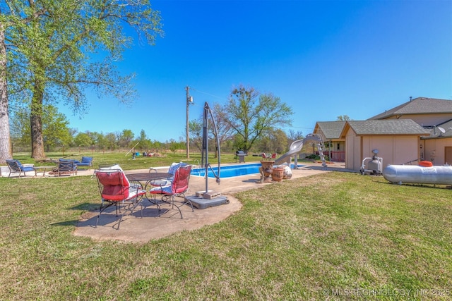 view of yard featuring a patio and an outdoor pool