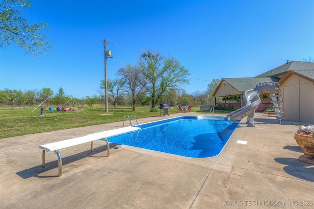 pool with a lawn, a patio, a water slide, a gazebo, and a diving board