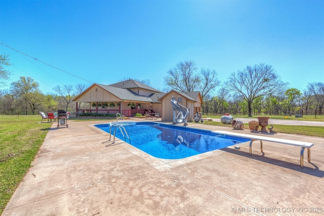 view of pool featuring a fenced in pool, a patio, a lawn, a water slide, and a diving board