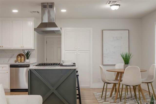 kitchen featuring stainless steel appliances, white cabinets, visible vents, and island exhaust hood