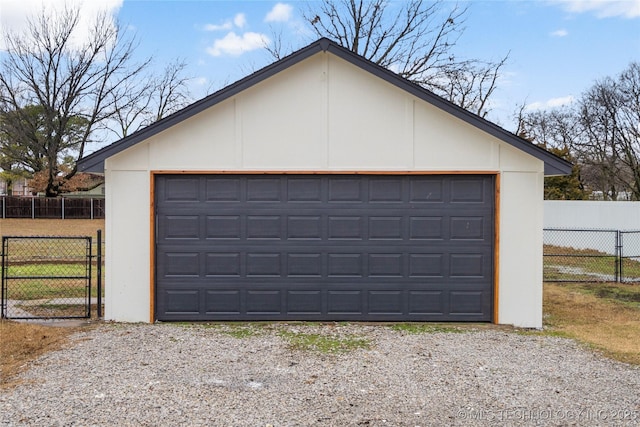 detached garage featuring fence