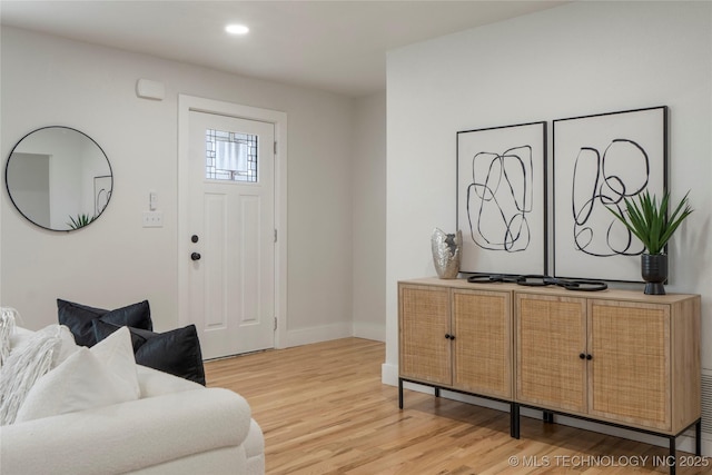 foyer entrance with baseboards, recessed lighting, and light wood-style floors