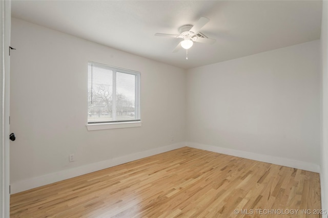 unfurnished room with ceiling fan, baseboards, and wood finished floors