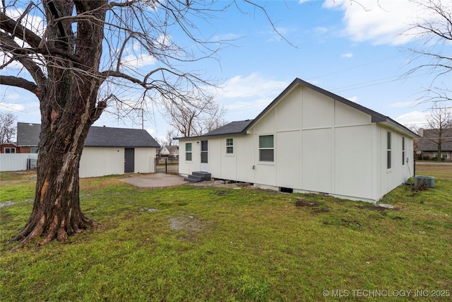 back of property featuring a patio, a lawn, and fence