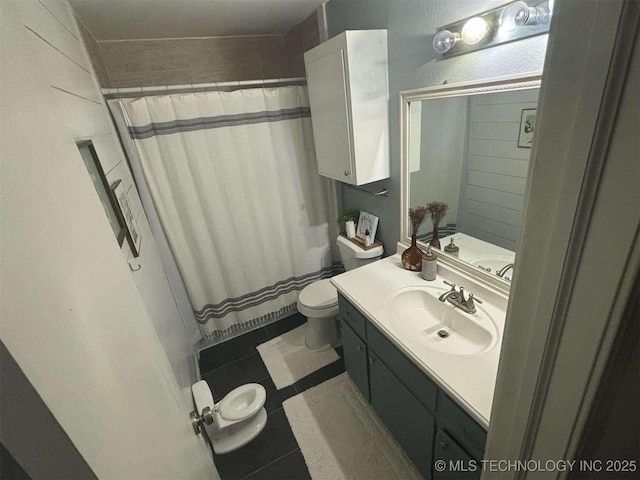 bathroom featuring toilet, curtained shower, tile patterned flooring, and vanity