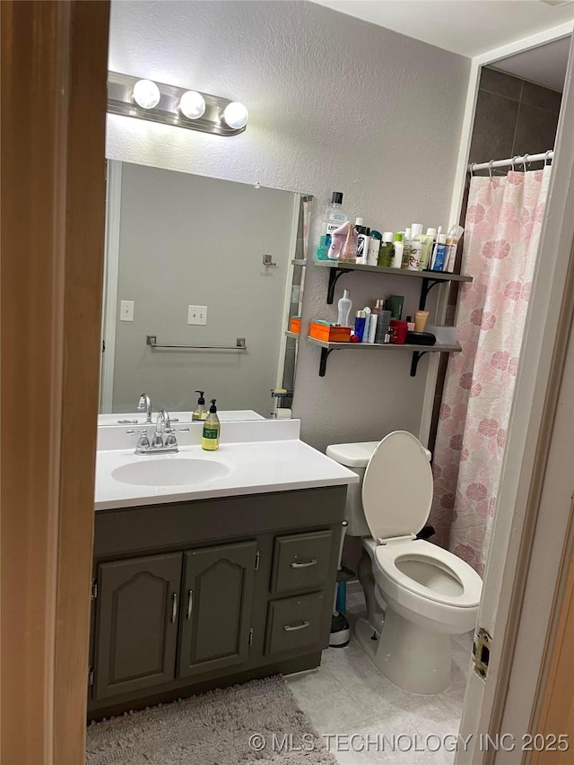 full bathroom with toilet, curtained shower, vanity, and tile patterned floors