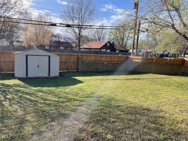 view of yard with an outbuilding, a shed, and a fenced backyard