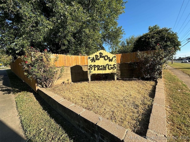 community sign featuring fence