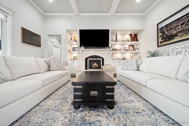 living room featuring built in shelves, crown molding, a fireplace, and beamed ceiling