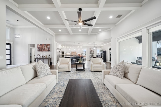 living area featuring recessed lighting, ceiling fan with notable chandelier, coffered ceiling, visible vents, and beamed ceiling