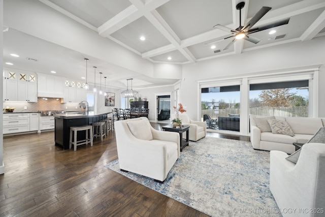 living area featuring visible vents, coffered ceiling, dark wood finished floors, beam ceiling, and recessed lighting