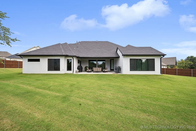 back of property with a patio area, fence, a lawn, and stucco siding