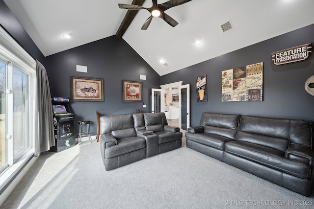 carpeted living room with high vaulted ceiling, ceiling fan, visible vents, and beamed ceiling