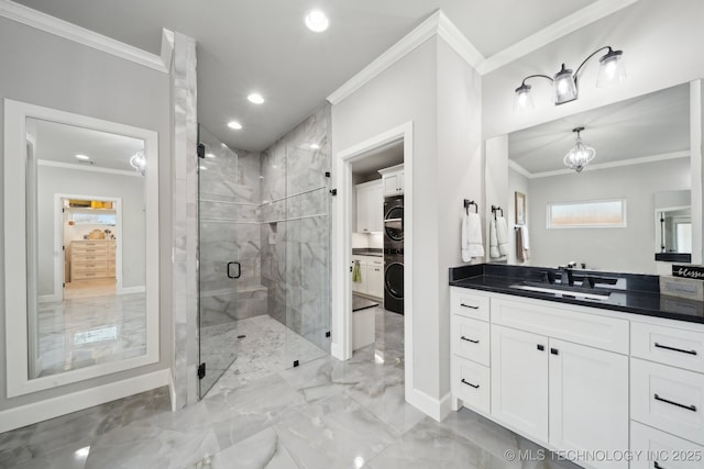 full bath with stacked washing maching and dryer, marble finish floor, ornamental molding, and a stall shower