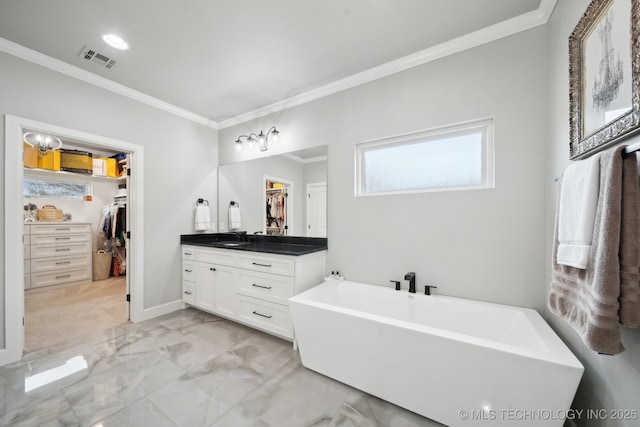 bathroom with a freestanding tub, vanity, visible vents, marble finish floor, and crown molding