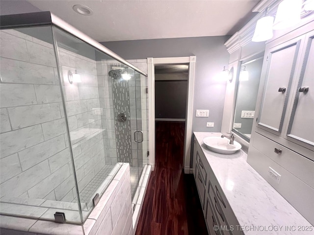 bathroom with a stall shower and vanity