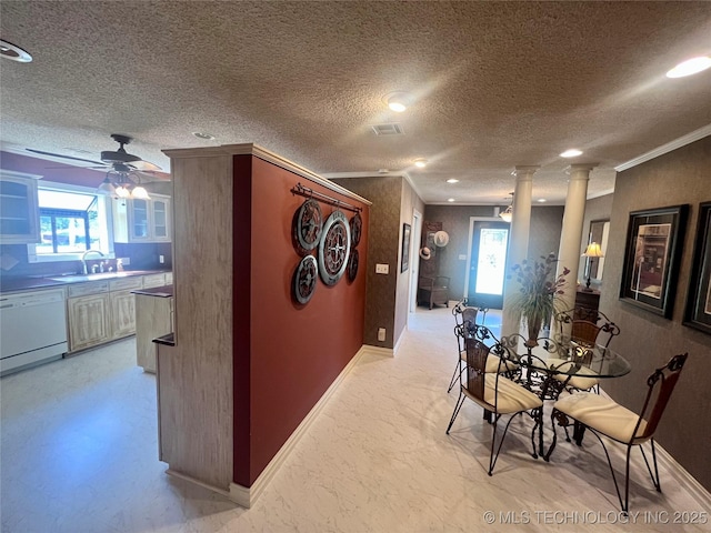 dining space with baseboards, decorative columns, ornamental molding, and a ceiling fan