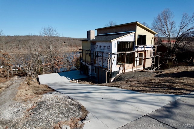 view of property exterior featuring a chimney