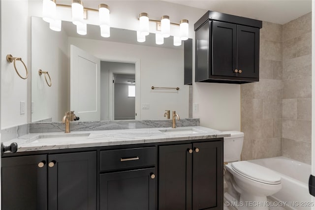 bathroom with a sink, toilet, and double vanity