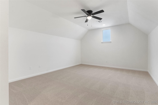 bonus room with light colored carpet, visible vents, a ceiling fan, vaulted ceiling, and baseboards