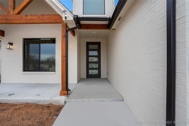 entrance to property with brick siding