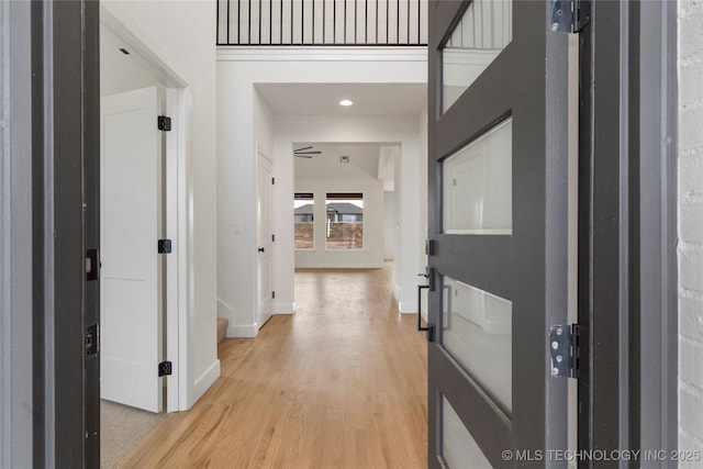 foyer with light wood finished floors, recessed lighting, and baseboards