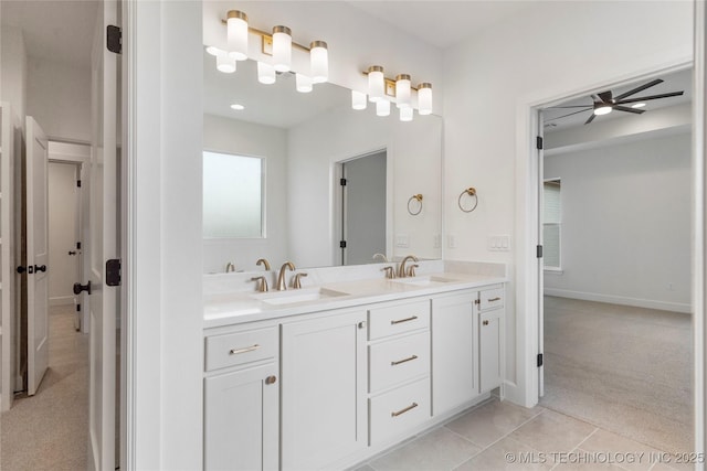 full bath with a ceiling fan, double vanity, a sink, and tile patterned floors