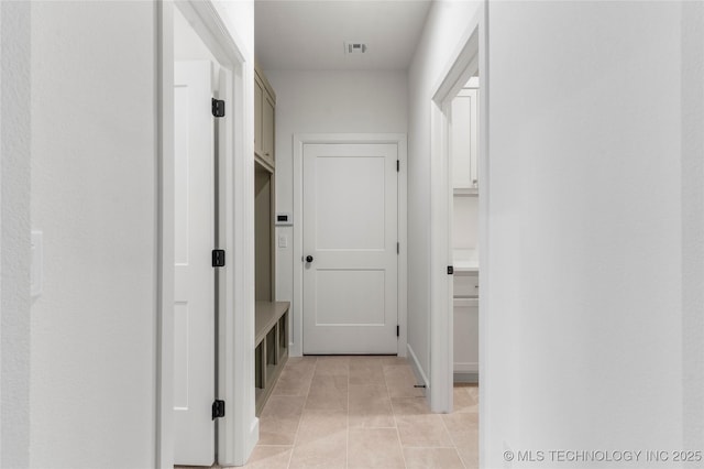 mudroom featuring light tile patterned floors and visible vents