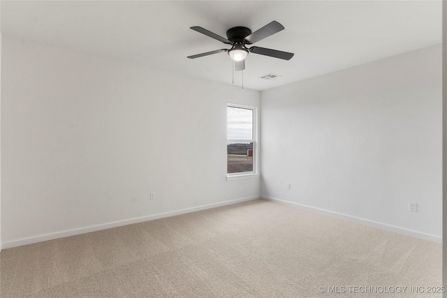 spare room with light carpet, visible vents, and baseboards