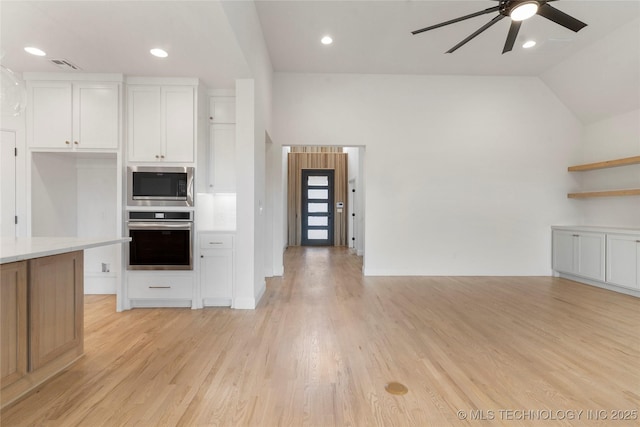 kitchen featuring visible vents, white cabinets, light countertops, appliances with stainless steel finishes, and light wood-type flooring