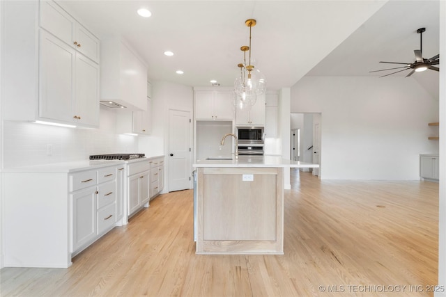 kitchen featuring stainless steel appliances, light countertops, and light wood-style flooring