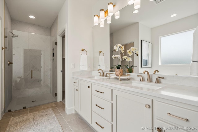 bathroom with visible vents, a sink, double vanity, and a stall shower