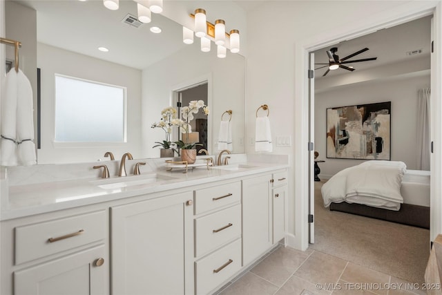 bathroom featuring tile patterned flooring, visible vents, a ceiling fan, a sink, and ensuite bath