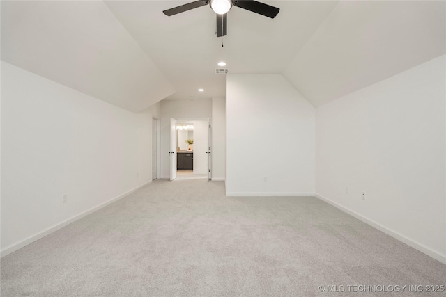 additional living space featuring vaulted ceiling, baseboards, recessed lighting, light colored carpet, and ceiling fan