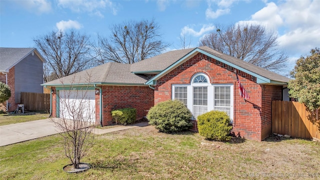 view of front of property featuring a garage, a front yard, fence, and brick siding