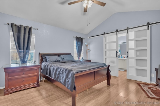 2517 Westwood, Ardmore, OK 73401 - bedroom featuring a barn door, light wood finished floors, lofted ceiling, a ceiling fan, and baseboards